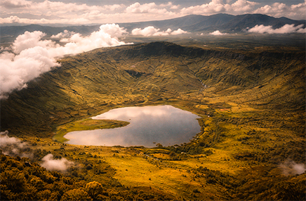 Aerial view of Ngorongoro Crater in Tanzania showcasing lush caldera landscape and central lake