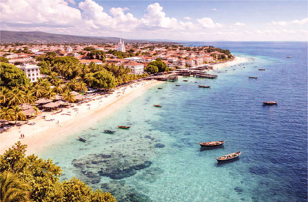 Aerial view of Zanzibar coastline with turquoise ocean, white sand beach, palm trees and traditional boats